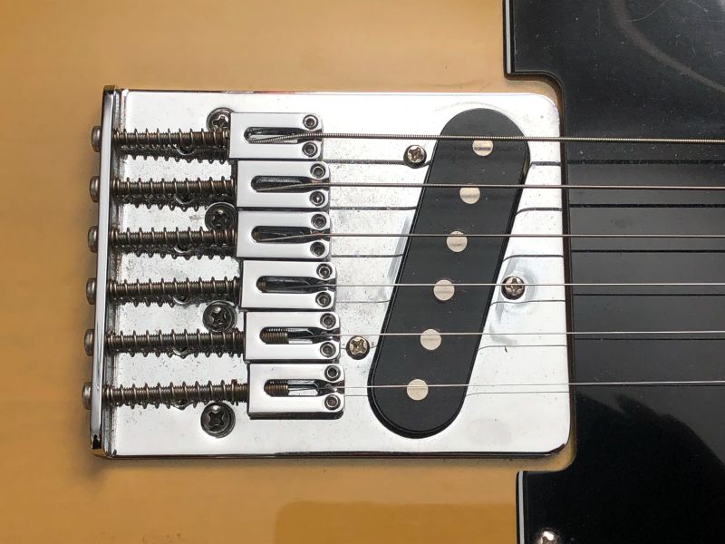 Longer screws move the saddles into position to accept a short scale neck.